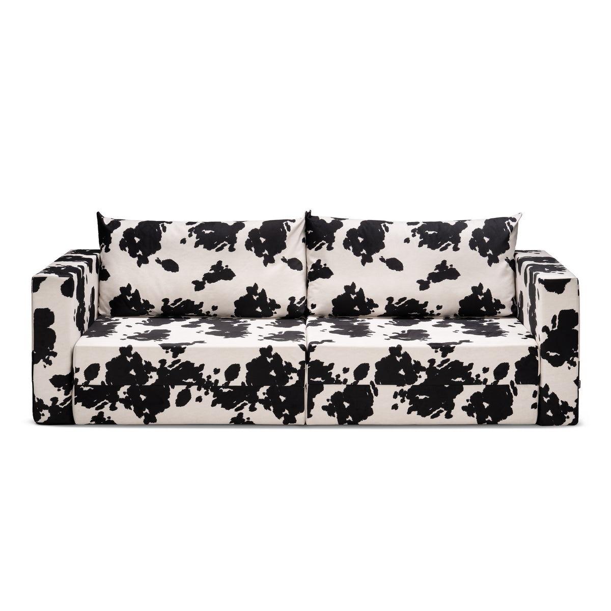 Flow Cow sofa bed in black-and-white cow print fabric with a green metal frame, front view