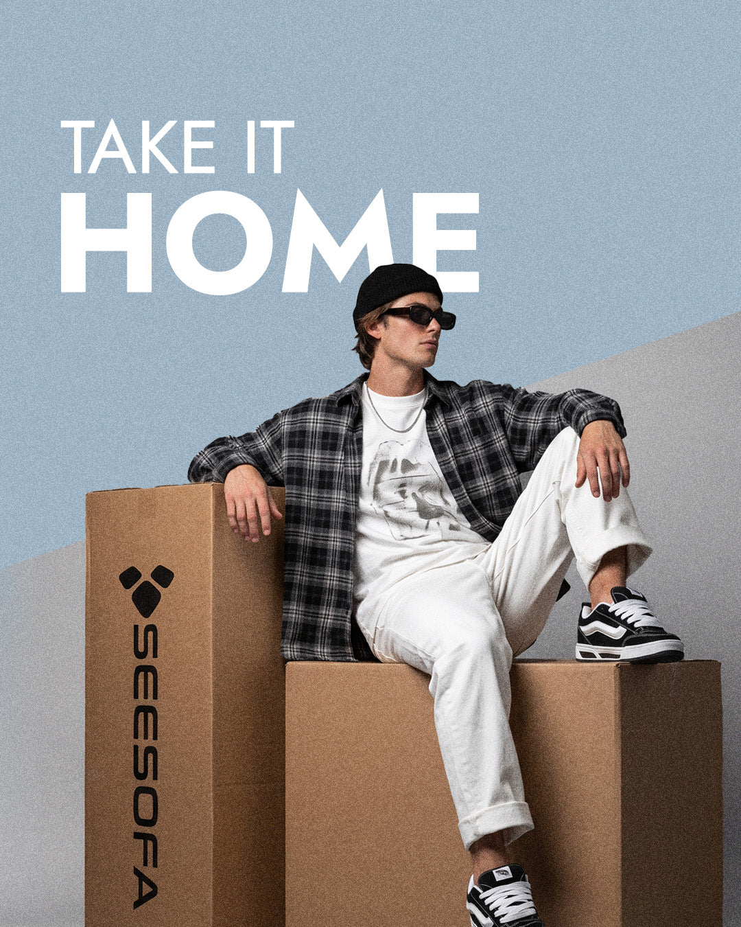 Take it home: man sitting on Seesofa delivery boxes