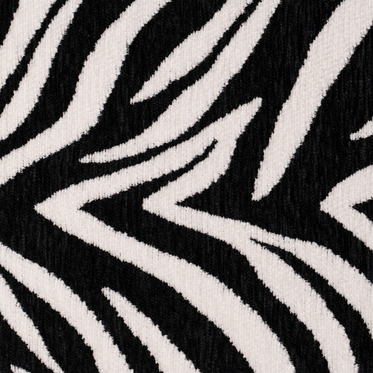 Flow Zebra sovesofa i sort-hvidt zebramønster med rødt metalstel, nærbillede af zebramønsteret