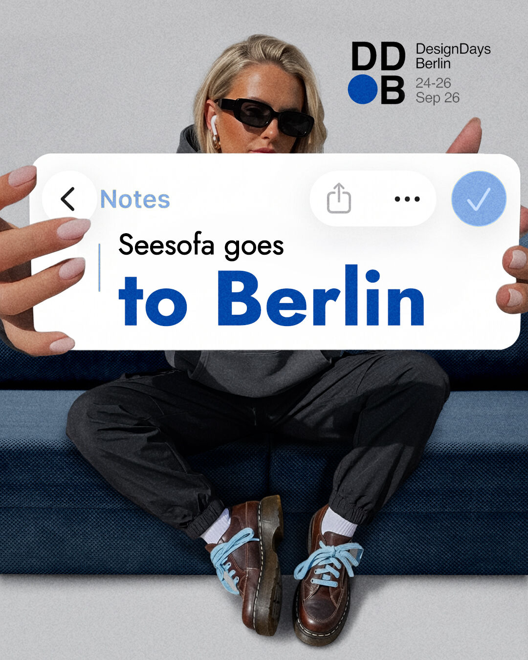 Woman sitting on a blue Seesofa sofa – Seesofa goes to Berlin for Design Days Berlin