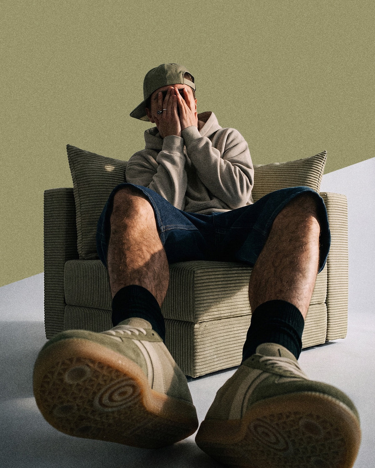 Man sitting on a khaki Seesofa chair bed
