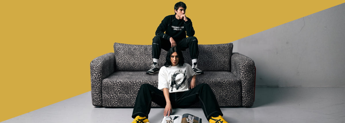 Two people on a Flowy Leopard sofa bed in grey leopard print fabric